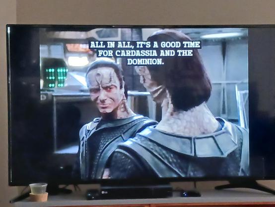 Damar and Gul Dukat from Star Trek Deep Space 9. Damar has a shit-eating grin as he tells Dukat, "All in all, it's a good time for Cardassia and the Dominion."

Cardassia and the Dominion are evil af.