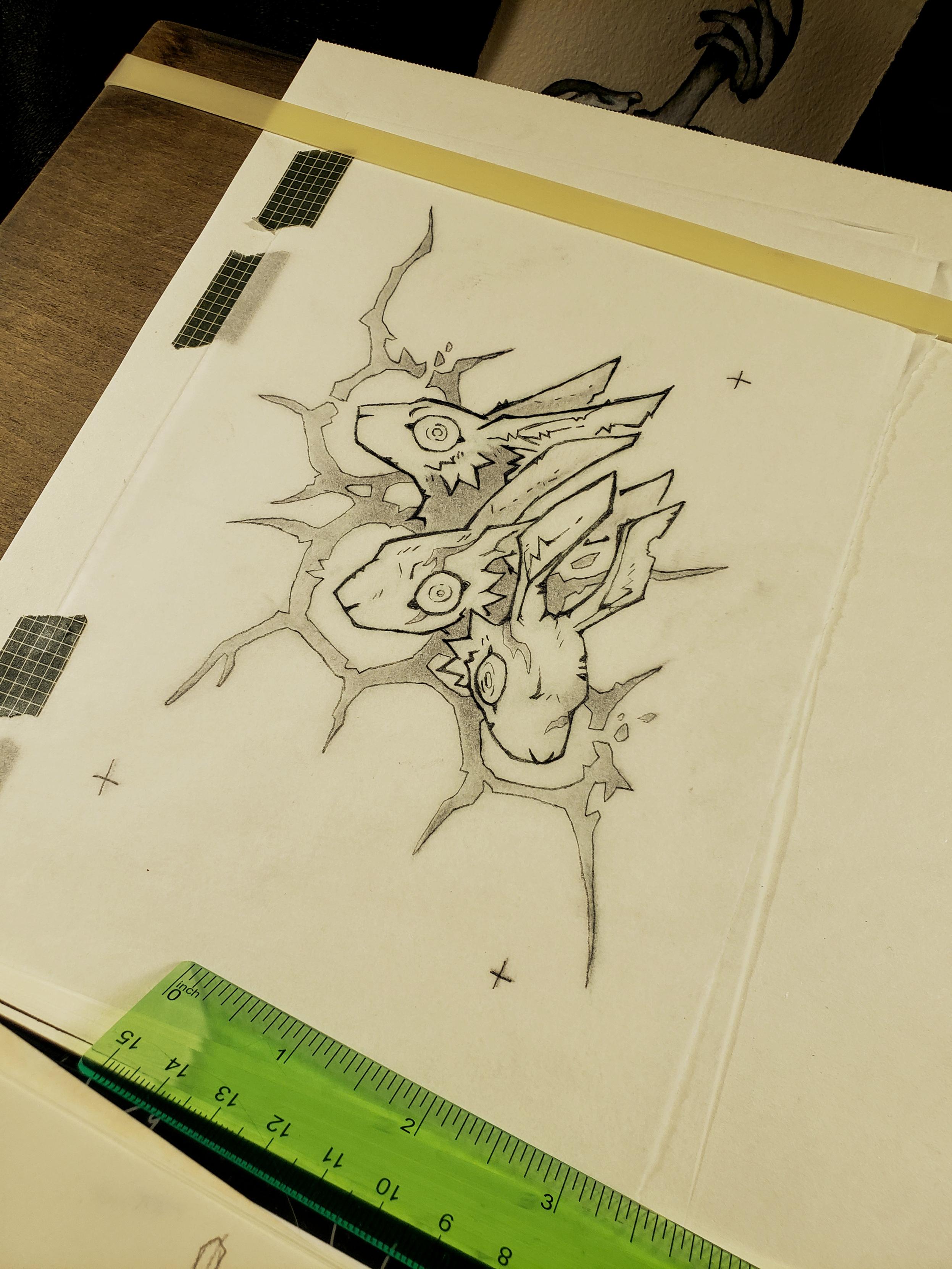 Photo of a sketch of several rabbits with wide eyes framed by an abstract shape.