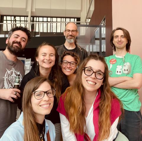 Colorful photograph of 7 smiling researchers. By Alessia Galdeman
