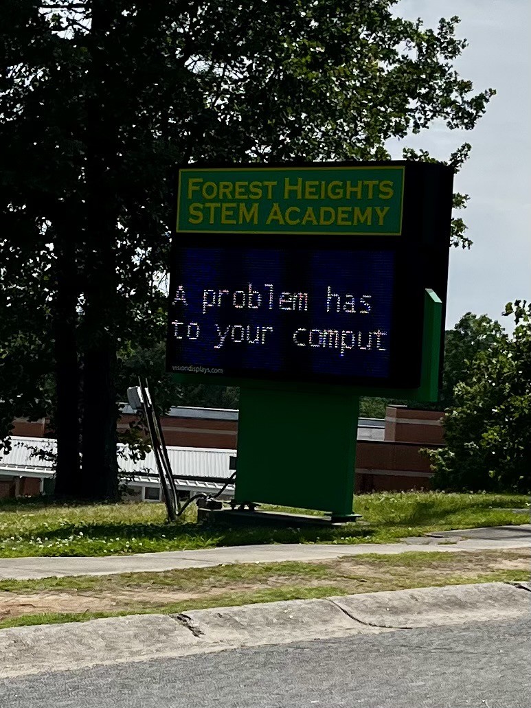 A digital school sign near our home with a blue screen that says "a problem has to your comput"