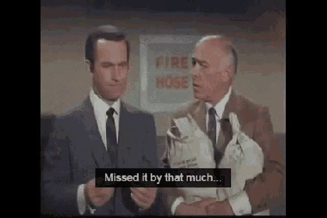 gif from the TV show Get Smart where agent 86 is standing next to the chief who is holding some bags.  he raises his fingers up and show they are close together as the caption reads "missed it by that much".