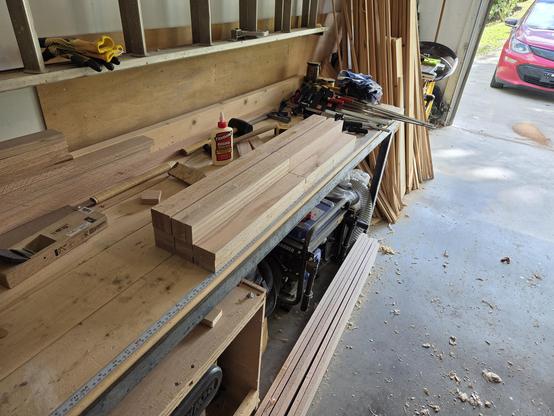 all 5 legs fully assembled but not yet planed to size.  legs are sitting on my workbench.  lots of clamps are visible in the background.