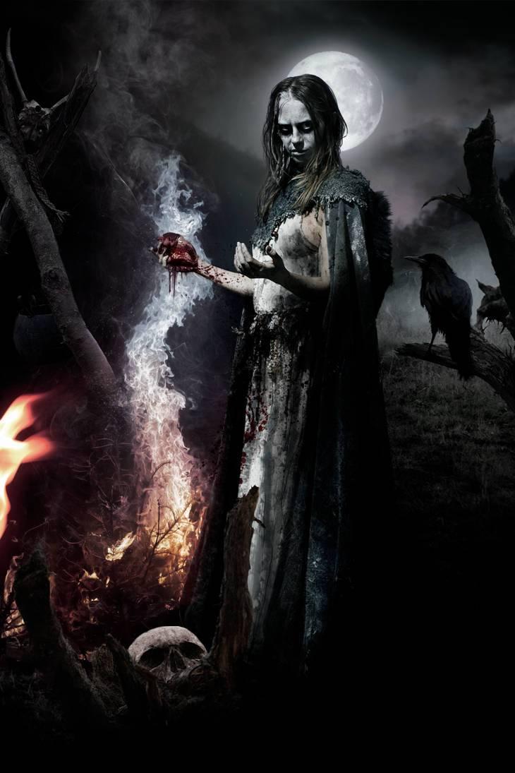 A depiciton of the Volva of Norse myth, a ghostly woman in a tattered turquoise cloak, potentially topless but not nude, with a dirty skirt. Her face is painted white with black around her glowing eyes, and she holds a bloody heart in her hand over a fire. Three ravens are around her, and the moon glows behind her head like a halo.