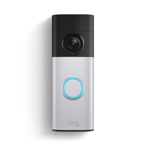 A Ring doorbell. Its design is simple, almost spartan. The bottom part has a button with a blue ring around it, the top part is black and has a camera. The camera looks at you ominously. Who is watching from the other side?