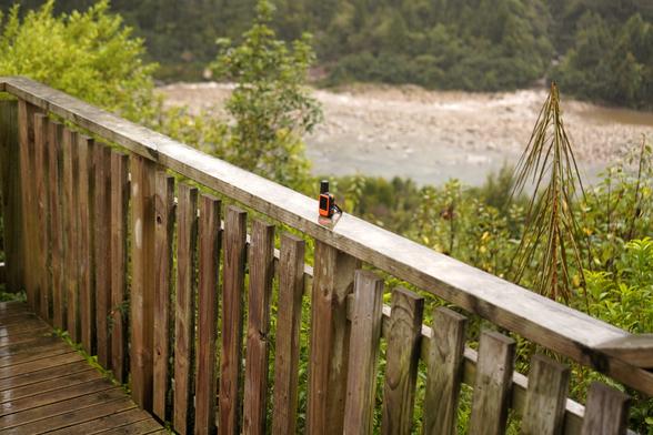 inReach satellite communication device waiting for the weather on a railing outside the hut.