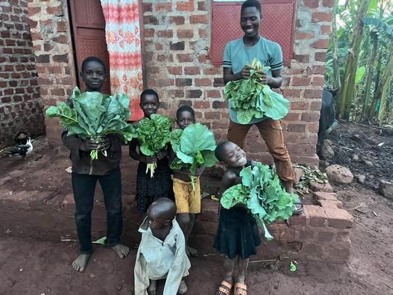 Children being served with vegetables and food from the garden.