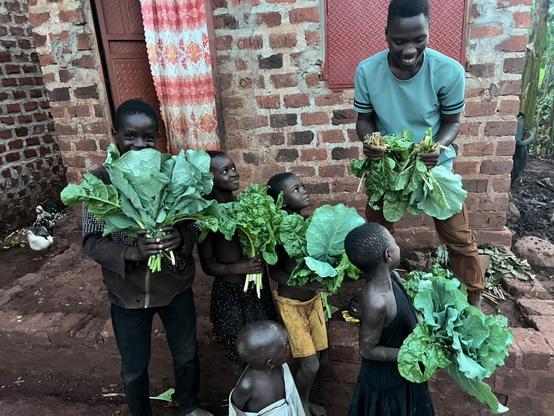 A smile on children's faces after getting vegetables and bananas for food.