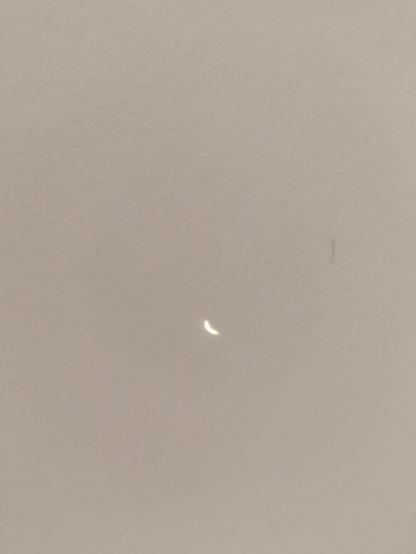 projected image of the sun at circa 75 to 80 percent occlusion by the moon