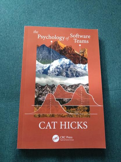 Photo of a book cover, "The Psychology of Software Teams" by Cat Hicks.