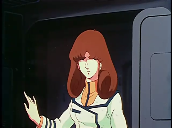 A screenshot from the 1982 anime SDF Macross. It's a close-up shot of Misa Hayase entering the bridge of the Macross. She's a light-skinned woman in a sci-fi officer uniform, with long brown hair in a style very representative of the time; it falls straight down, with bangs trimmed just over the eyes, and the rest curling in a large whorl over each shoulder.