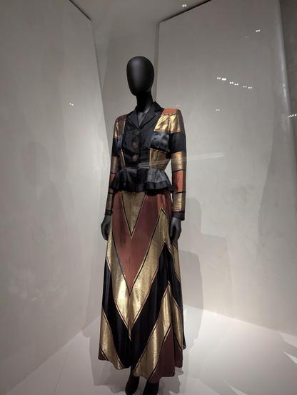 Gold, black and rust red geometric fitted evening dress with soft sheen.