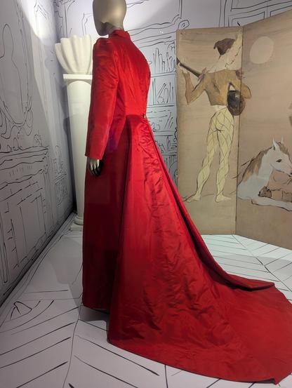 Bright red long sleeve silk/taffeta full length coat with train and deep pleat at back.