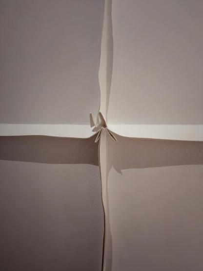 Four pieces of blotter with folded edges projecting forward. Pieces secured with corner folds.