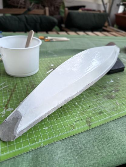 The hull of the model is upside down and was coated with white primer.