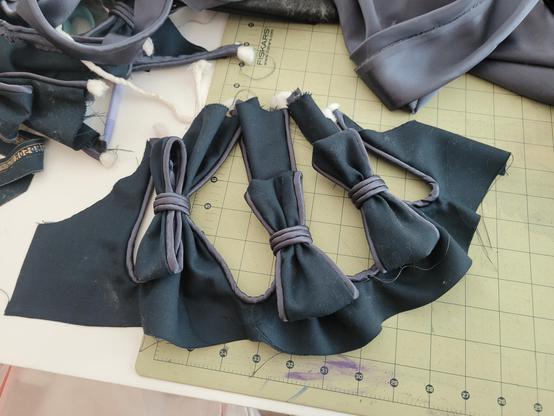 One sleeve cap, slashed piped and with bows.