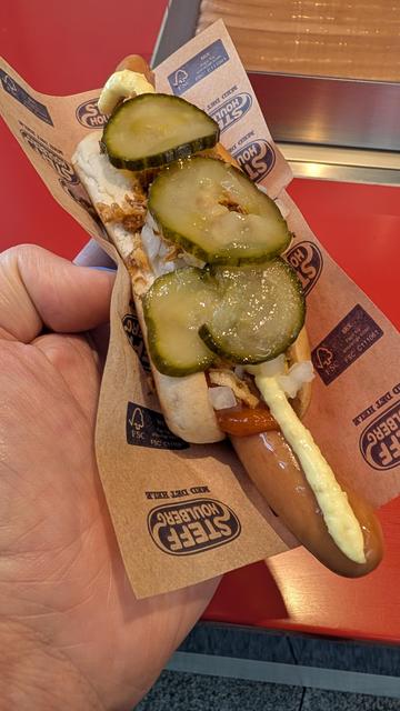 Holding the Danish haute cuisine that is a "risted med det hele". A hot dog with all the relish, two styles of onions and pickled cucumber. NOM!