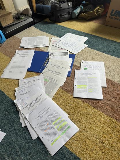 20 or more academic papers about databases spread out on a floor of a room. They all have handwritten notes on them, coloured highlight markings and other signs of being read. Most are from the 21st century, though there are some from the 1970s
