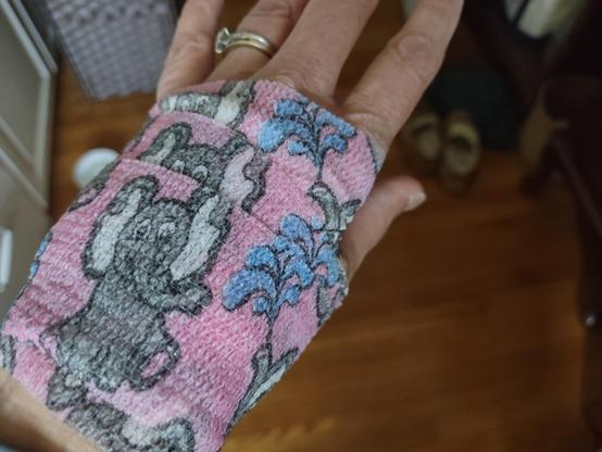 A picture of my hand wrapped in stretchy tape with cute cartoon elephants.