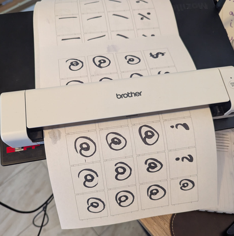 Photo of my Brother scanner digitizing pages of letters I inked with a Sharpie that has a big chisel tip. I wouldn't call my hand-writing calligraphy by any stretch, but I guess that makes the font interesting.