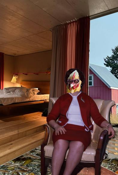 Digital collage of a chicken headed woman in a red skirt suit and white blouse sitting in a cream coloured chair. Below her a school of fish swim through the floor. Stairs lead up to a bed / sleeping area. Through open curtains a red barn is visible.