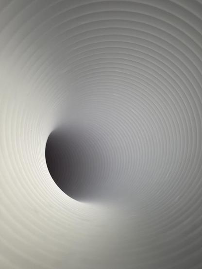 A closer shot down the aircon outlet tube. The corrugations are visible all the way down.
