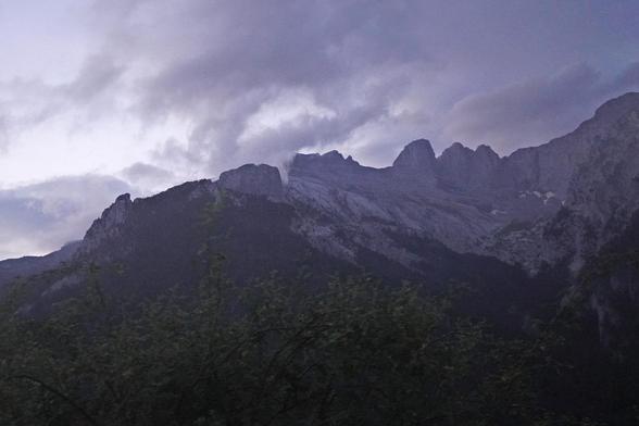 A lot more clouds and dark sky behind the rocky alpine terrain of the Muses Plateau. We are above treeline here and it's all grey.