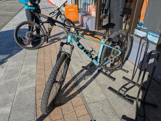 A clean Trek mountain bike, cyan frame. It was much less clean later in the day.