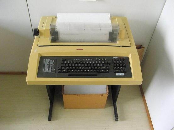 A "Decwriter" -- a 1970s teletype. Couldn't find a portable model that looked like I remember,. But it was similar to this. There is no screen -- you type in commands and it types out responses from the computer. On paper.