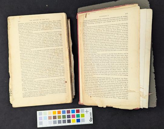A decades old book displayed open showing full separation of the textblock and the back cover.