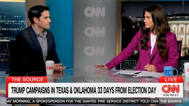Clip of The Source TV news desk, where Collins is interviewing Harry Enten. Collins mug is in front of her left arm, turned so that the viewers can read its inscription, which is in block letters: "AMERICA NEEDS NASTY WOMEN"