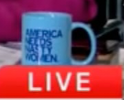 Close up of the mug, blurry because its a zoom-in from the prior photo, of the light blue mug, with dark blue lettering, using block letters to say: "AMERICA NEEDS NASTY WOMEN"