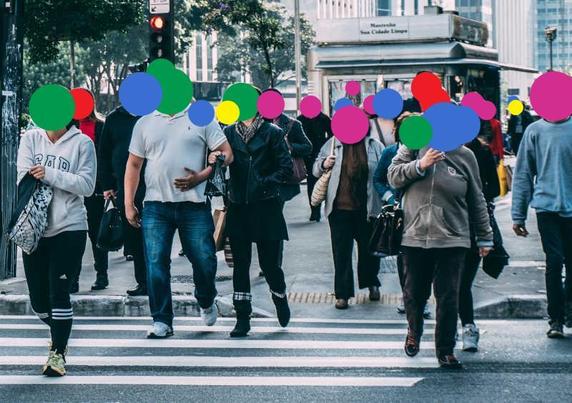 The original example image from deface tool: a bunch of people crossing a street at a zebra crossing. Every face is covered by a colored disk, randomly green, blue, pink, red or yellow.