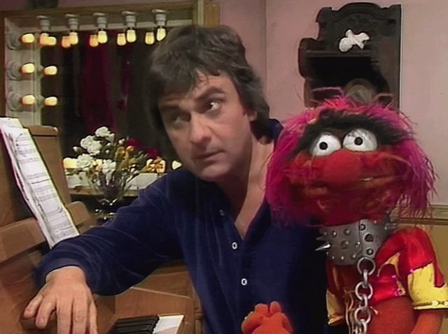 GIF of Animal attacking Dudley Moore in his dressing room, causing Floyd to rush in and watch