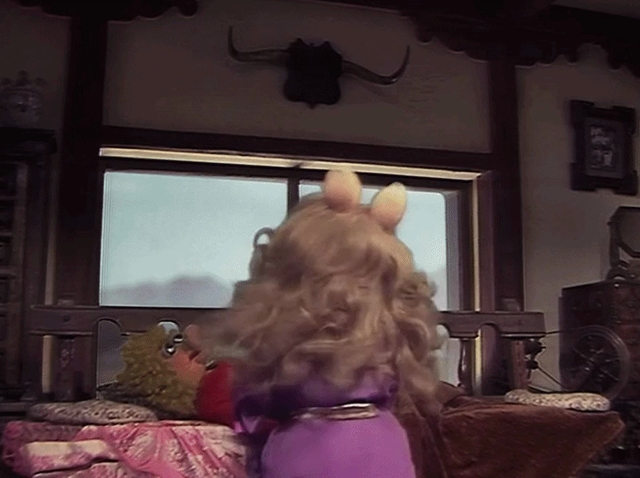 GIF of Miss Piggy spinning in a circle and transforming into Wonder Pig