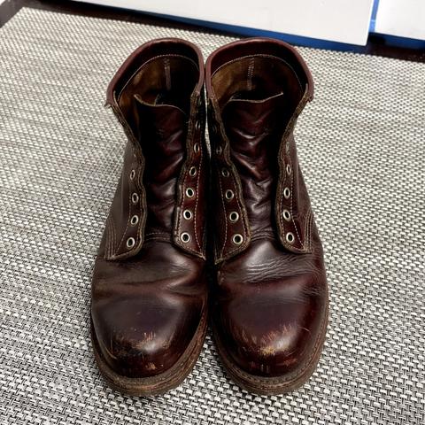 A pair of well-loved leather work boots without laces