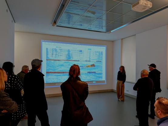 Olia Lialina and gallery visitors in front of the artwork "Hosted"