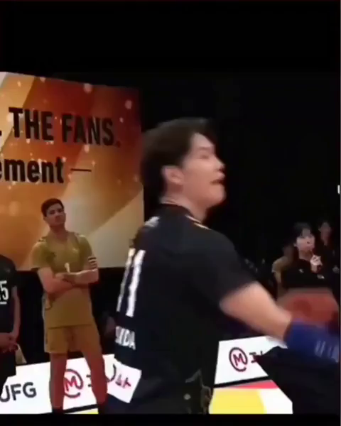 A volleyball player's serve hits a line judge. The player proceeds to sprint into a sliding bellyflop ending at the judge's feet completely prone