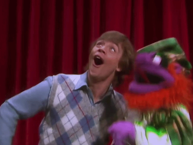 GIF of Mark Hamill and Angus McGonagle the the Argyle Gargoyle gargling Gershwin gorgeously together