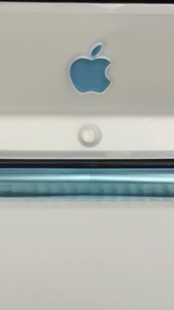A short video with no sound tightly focused on the lower portion of a blueberry iBook LCD screen. Below the blue Apple logo is a green LED that gets brighter, then dimmer, repeatedly, to show system sleep.