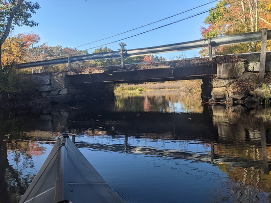 The narrow river passes under a road/