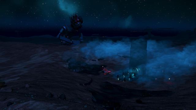 In the foreground there is a mist shrouded tall black monolith with a stargate like circle in the bottom and a few short pillars along the walkway to the gate, and a small red star fighter parked next to the monolith.

In the background is a giant crouched grey robot with arms, and red and black spikes evoking hair or a crown looking down on the portal.

To build the robot someone carefully resized and rotated a bunch of different build objects in strange orientations to make the sculpture.

Unfortunately the photo is at night, and it's a rocky planet, so everything is shades of black and grey.