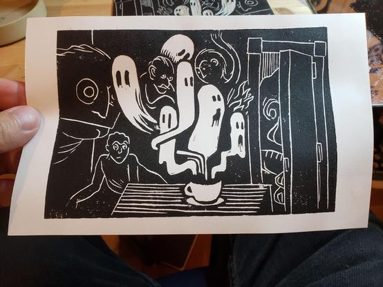 Print of a lino cup: a bevy of ghosts escaping a coffee cup, while a variety of creatures look on in alarm