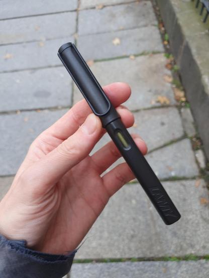 I'm holding the very pen in my hand in broad daylight. Not green at all, neither dark nor any other shade, except maybe black green.