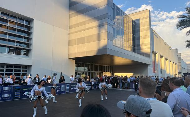 some scantily clad women damcning in front of a bunch of leering data centre executives