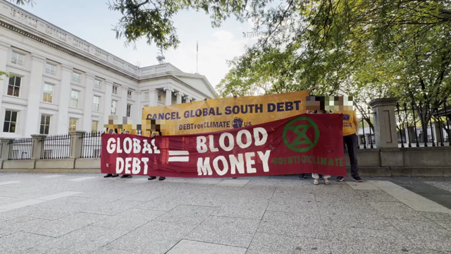 Protesters chant "for people and planet, cancel the debt!"