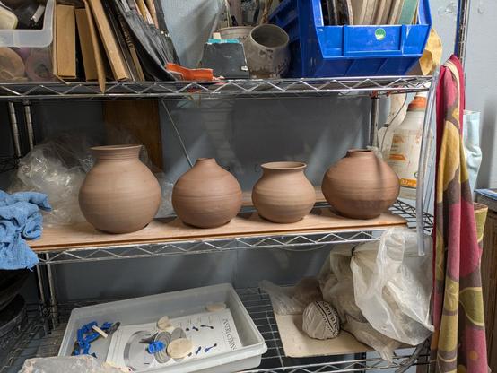 Four trimmed vases.