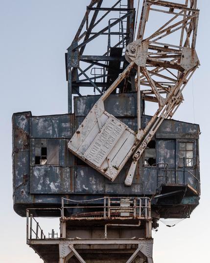 Part of an old, rusting crane. You can see the name Stothert & Pitt, Bath, England formed as part of the structure. Clearly none of these elements have moved, in years.