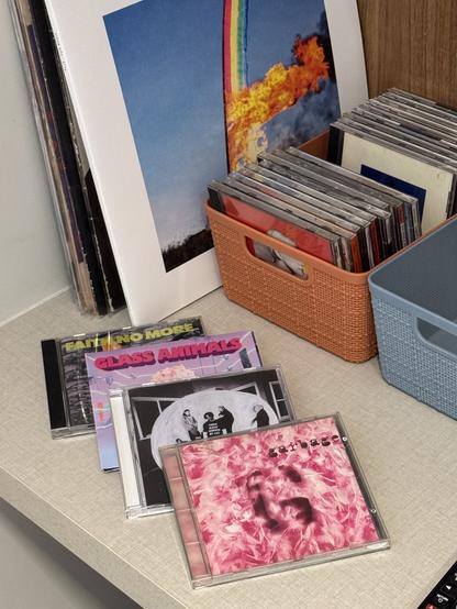 Four CDs on display: Faith No More’s The Real Thing, Glass Animals’s Dreamland, Portugal. The Man’s Chris Black Changed My Life and Garbage’s 1995 self-titled album. They’re next to a wider selection of vinyls and CDs.