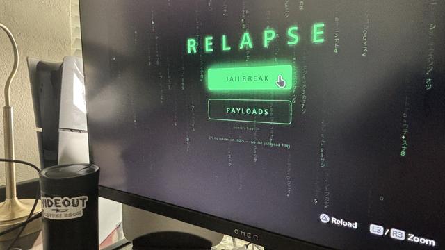An image of a computer screen displaying a software interface titled "RELAPSE" with options for "JAILBREAK" and "PAYLOADS." The background features a digital, green-themed design resembling code or data streams. A black travel mug labeled