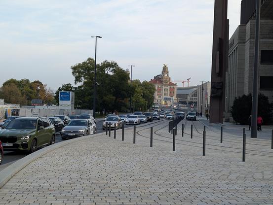 3-lane highway in the other direction coming from the train station, with tram tracks in between.